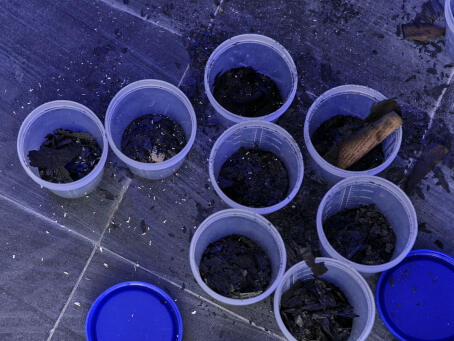 Allen-Golder Carpenter - Free jah morant , 2025 Urine test cups, ash, projector, moving image, gemstones, urine. Spatial installation. Dimensions variable - TICK TACK