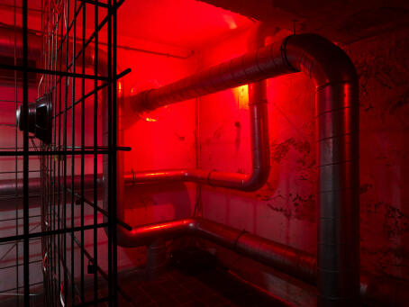 Hannah Perry, BPM (Thrash), 2026, air vent tubing, 12 subwoofers, rebar caging, padlocks, sound piece 8 min 10 sec, 245 x 180 x 180 cm